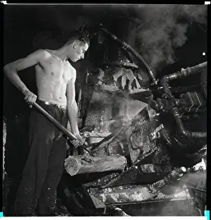 Grinding Prints: Man Placing Wood Into Machine
