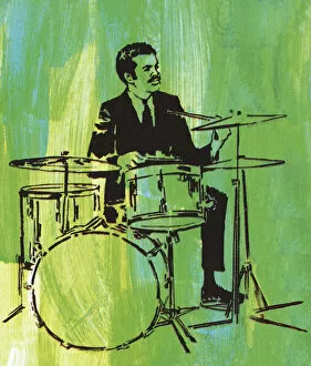 Images Dated 26th March 2014: Man Playing a Drum Set