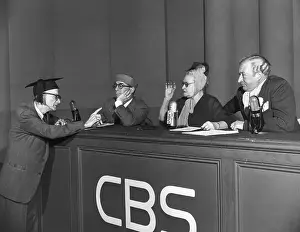 Man Pointing To Woman On Panel