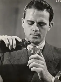 Man pouring medicine into glass