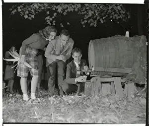Man Pouring Sweet Cider from Barrel for Couple