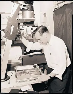 Printing Prints: Man Printing a Negative