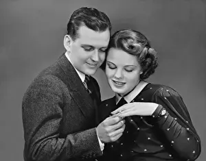 Man putting ring on womans finger