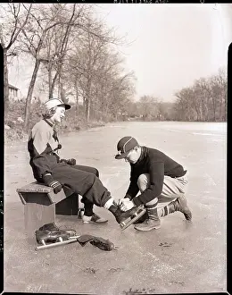 Tying Prints: Man Putting on Woman's Ice Skates