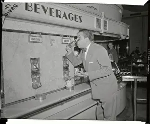 Man Removing His Eyeglasses to Read Posted Sign