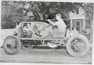 Man Riding in Open Framed Car