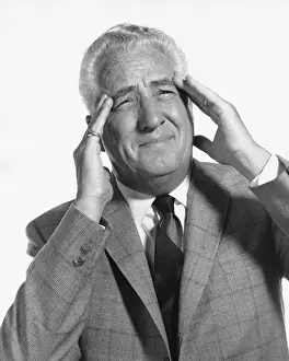 Necktie Prints: Man rubbing temples