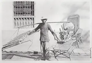 Man Saddled with Wicker Furniture