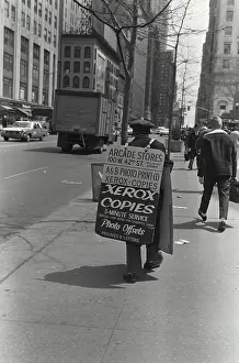 Urban Prints: Man with Sandwich sign over shoulders on New York 42nd Street in New York City