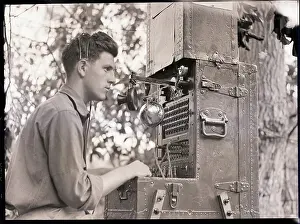 Panama Prints: Man Seated Behind Army Communication Equipment