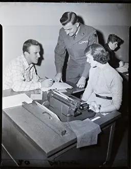 Man Seated At Typist Desk, Officer Over