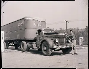 Man Servicing Truck at Gas Station