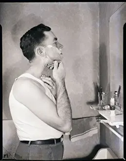 Man Shaving in Bathroom