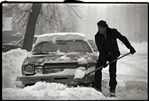 Shoveling Prints: Man Shoveling out Car