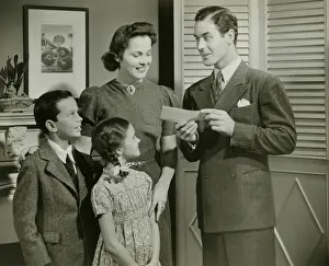 10 11 Years Prints: Man showing cheque or telegram to family