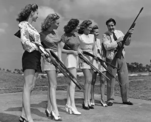 Man Showing Women how to Shoot