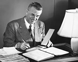 Grainy Prints: Man signing checks