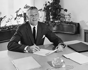 Necktie Prints: Man sitting at desk, holding paper and pencil