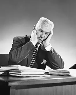 Necktie Prints: Man sitting at desk, leaning on elbows