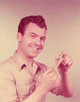 Only Mature Men Prints: Man smiling, opening pay day envelope