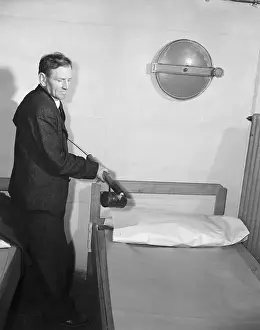 Spraying Prints: Man Spraying Hotel Bed with Ddt