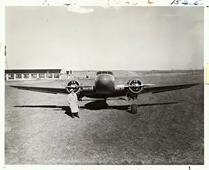 Man Standing with 1930s Aircraft