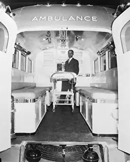 Man Standing Inside Large Ambulance Vehicle