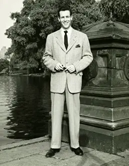 Man standing by lake in park, (B&W), (Portrait)