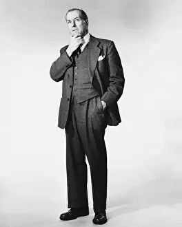 Man standing, rubbing chin