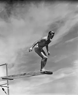Swimwear Prints: Man standing on springboard, preparing to dive, (B&W)
