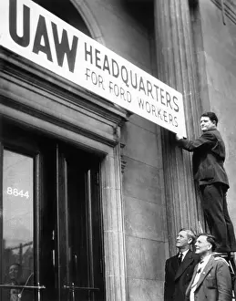 Union Prints: Man Stands Atop Ladder To Hang Sign