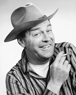 40 49 Years Prints: Man in stetson hat posing in studio, smoking cigarette, (B&W), portrait
