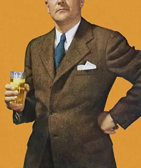 Man in Suit Holding Beverage