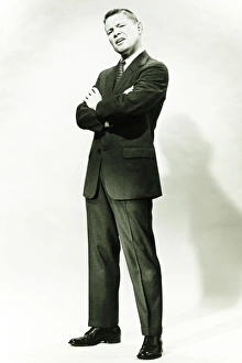 35 39 Years Gallery: Man in full suit making face in studio, (B&W), portrait