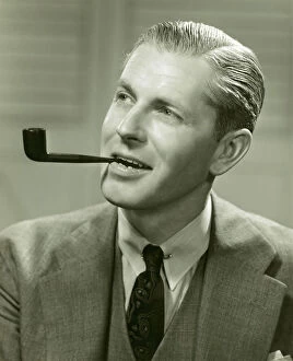 Man in suit smoking pipe