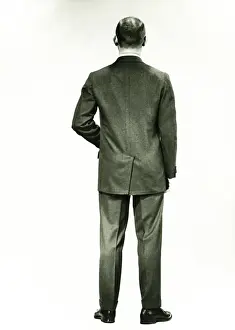 Hand In Pocket Prints: Man in full suit standing in studio, (Rear view), (B&W)