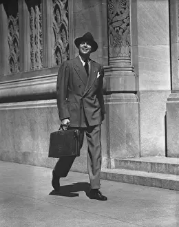 Sidewalk Prints: Man in full suit walking on sidewalk, (B&W)