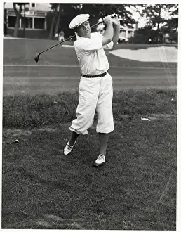 Man Swinging Golf Club