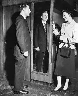 Modeling Prints: Man in Tailored Suit with Woman by Mirror