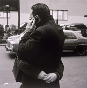 Images Dated 17th June 2004: Man talking on cell phone and hugging woman