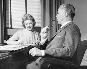 Businessman Prints: Man talking, woman taking notes
