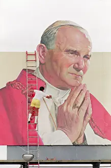 Billboard Prints: Man Touches up Painting of Pope John Paul II