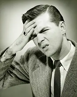 Worried Prints: Man touching forehead, suffering headache, (B&W)