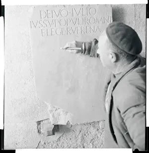 Man Tracing the Writing on a Lapidary Stone