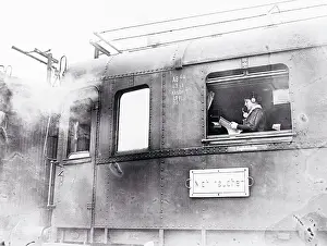 Man Using a Telephone in a Train