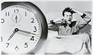 Man Waking Up To Alarm Clock