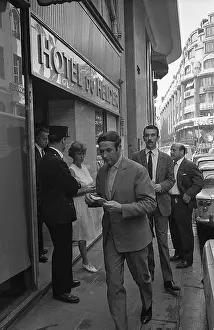 Man Walking Away from French Hotel