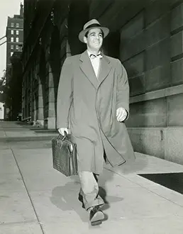 Briefcase Prints: Man walking along sidewalk