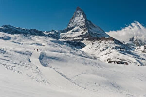 Images Dated 26th February 2012: a man walking on a snow trail with Matterhorn background