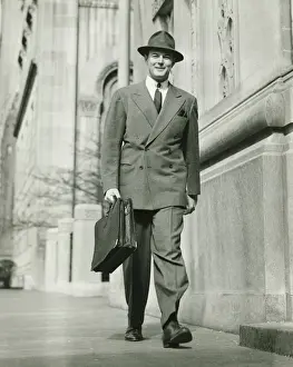 Sidewalk Prints: Man walking on street, carrying briefcase, (B&W)